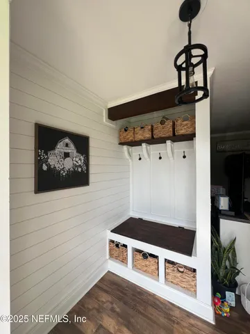 a bedroom with bed and wooden floor