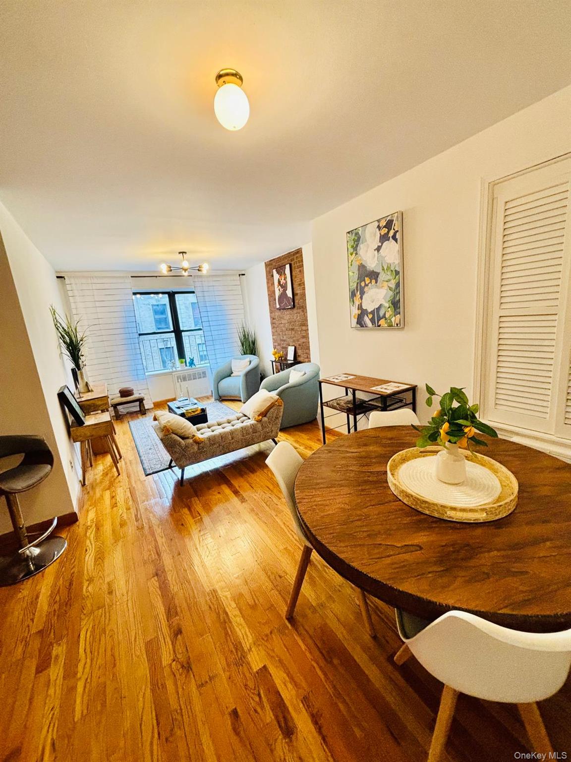 515 West 151st Street, Unit 4W Manhattan, NY 10031 - Photo 12 of 12 a living room with dining room and wooden floor