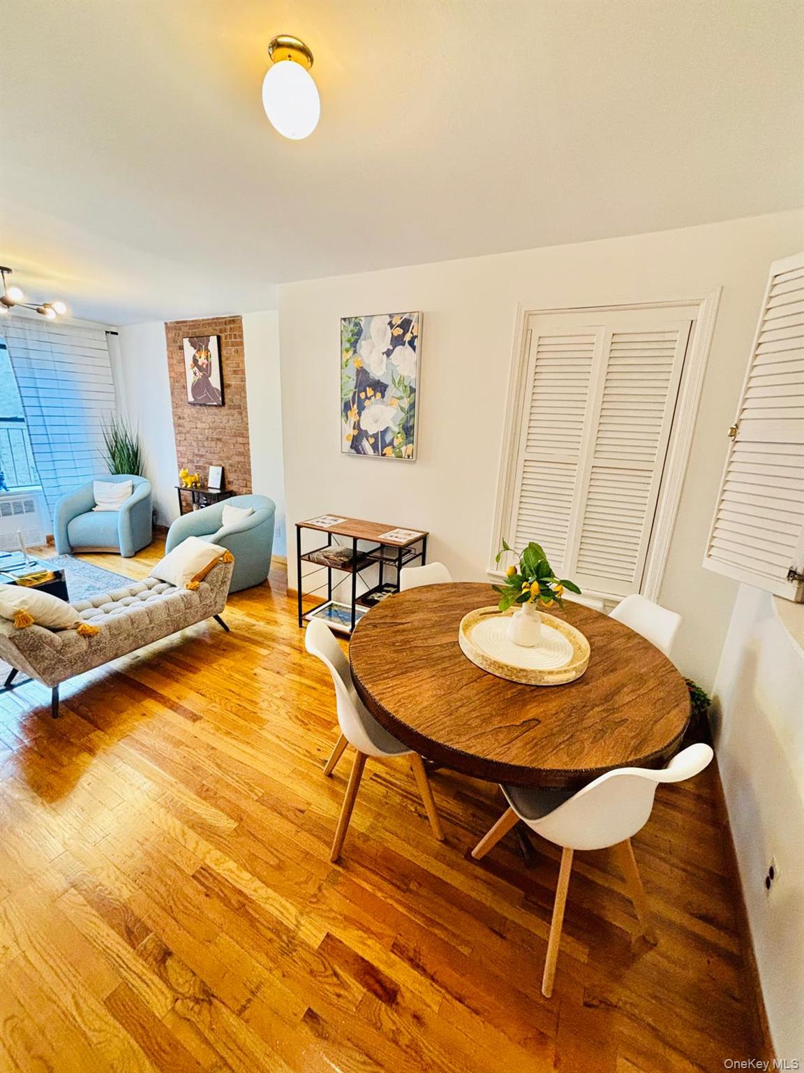515 West 151st Street, Unit 4W Manhattan, NY 10031 - Photo 5 of 12 a view of a dining room with furniture and wooden floor