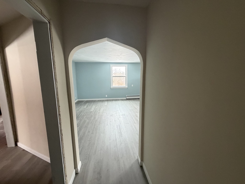 12 R Jackielyn Circle Granby, MA 01033 - Photo 19 of 23 a view of a hallway with wooden floor and a cabinet