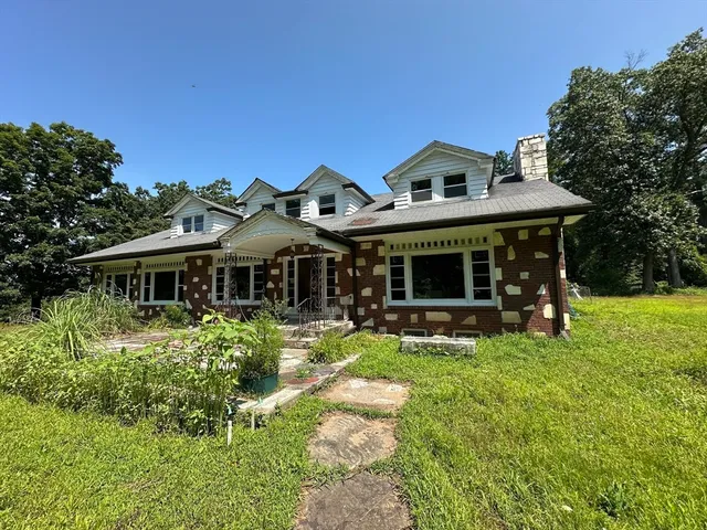 a front view of a house with a garden