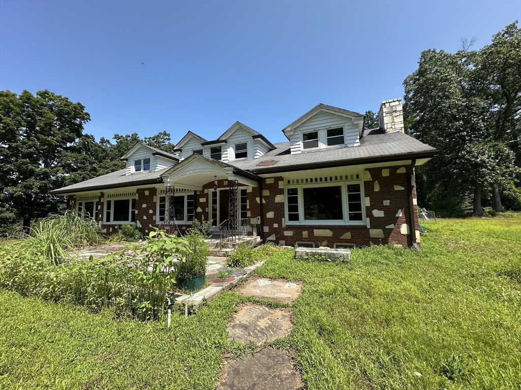 12 R Jackielyn Circle Granby, MA 01033 - Photo 2 of 17 a front view of a house with a garden