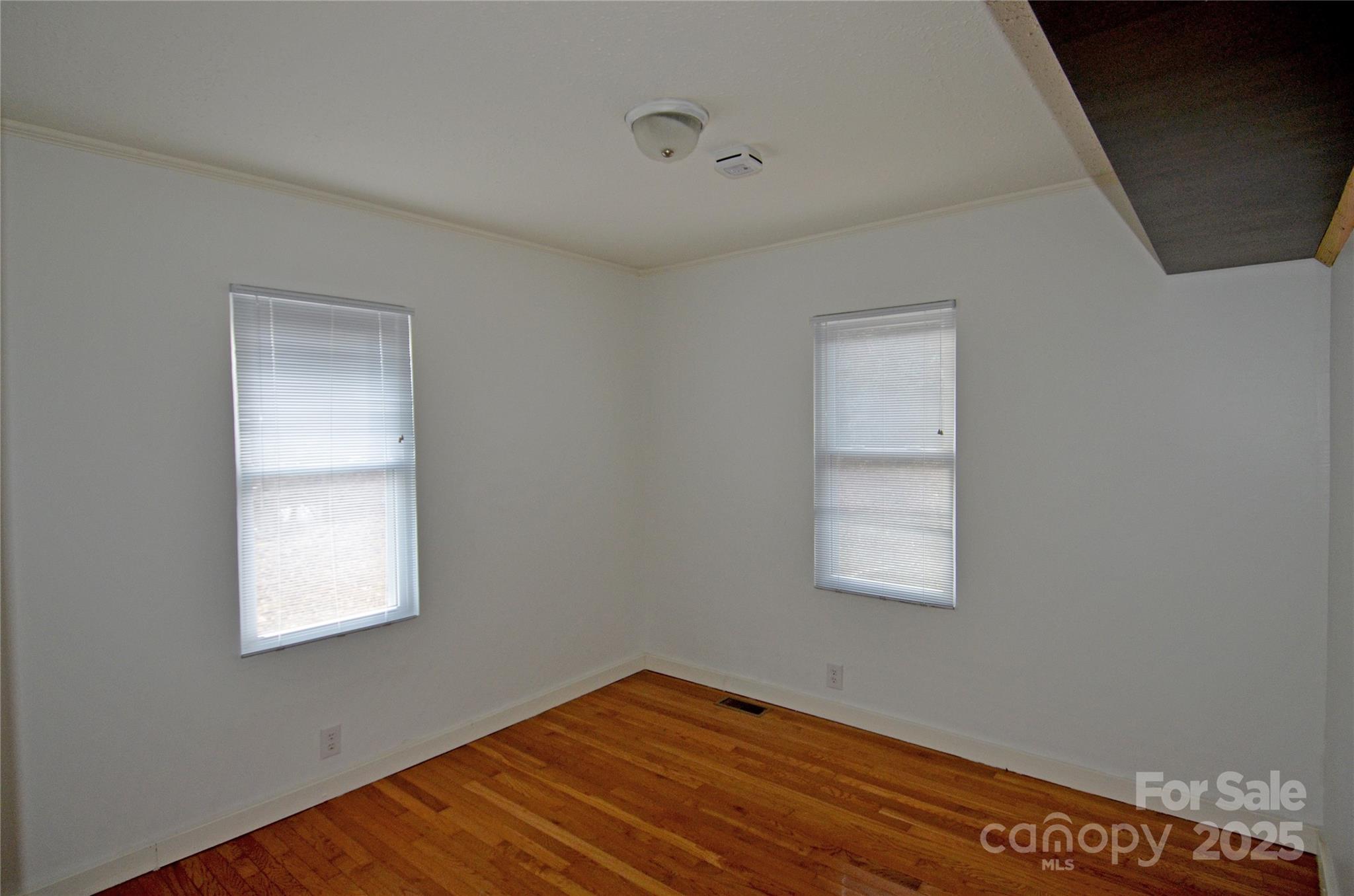 93 John Gilkey Road Marion, NC 28752 - Photo 11 of 13 a view of an empty room with wooden floor and a window