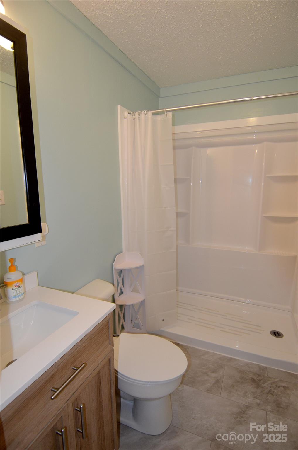 93 John Gilkey Road Marion, NC 28752 - Photo 12 of 13 a bathroom with a sink a toilet and shower