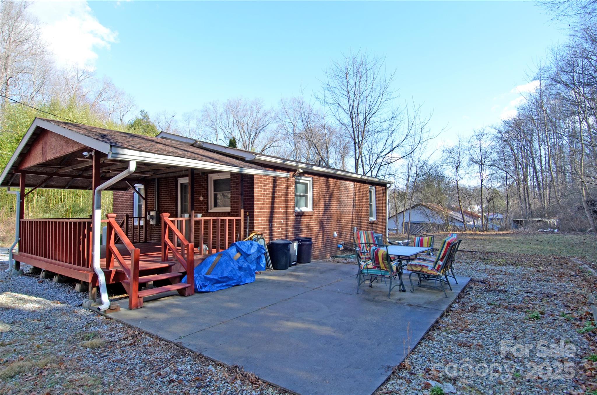 93 John Gilkey Road Marion, NC 28752 - Photo 3 of 13 a backyard of a house with childrens swings and furniture