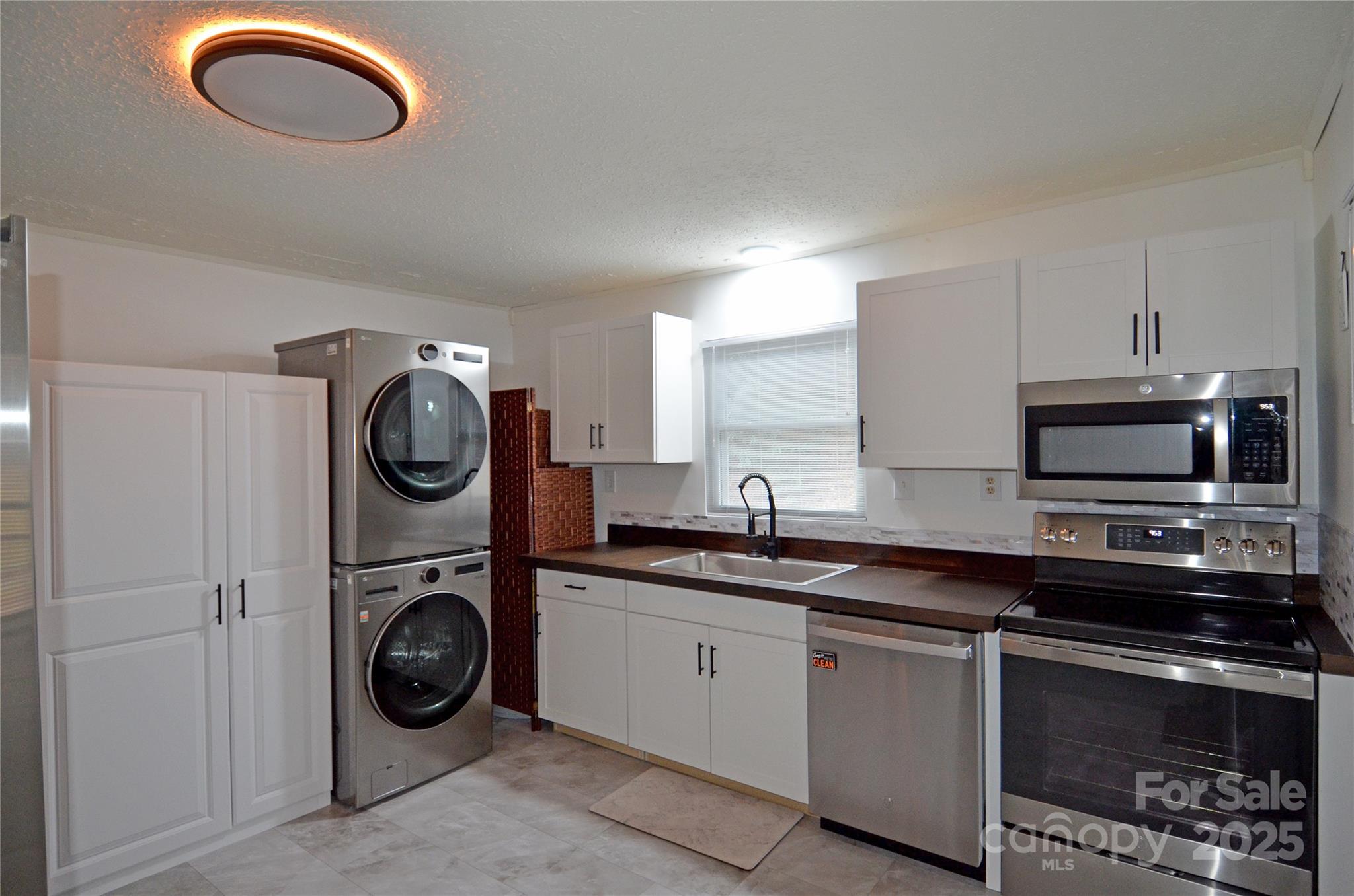 93 John Gilkey Road Marion, NC 28752 - Photo 10 of 13 a kitchen with a stove top oven sink and cabinets