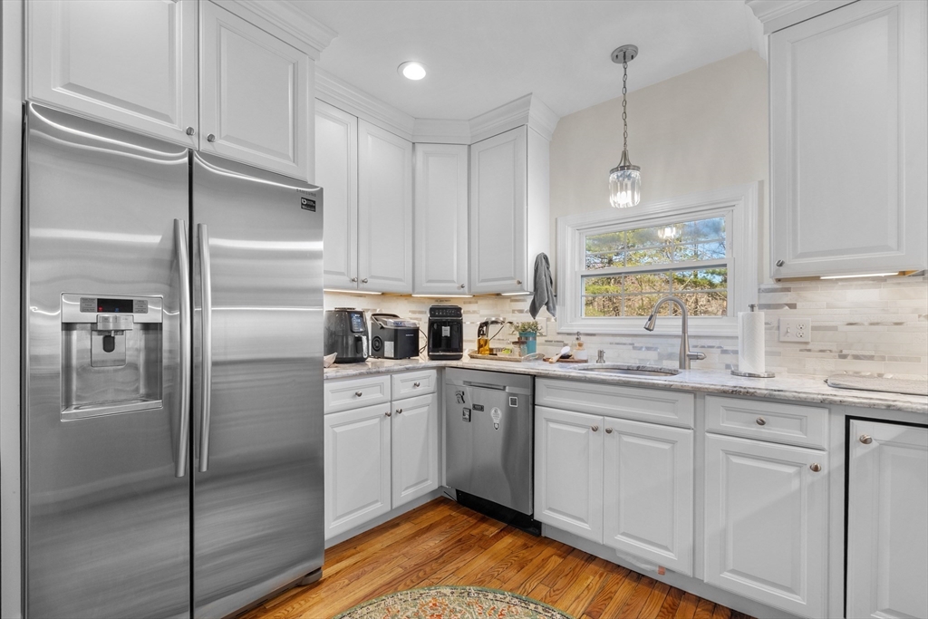 38 Brook Street Georgetown, MA 01833 - Photo 6 of 42 a kitchen with white cabinets stainless steel appliances and a sink