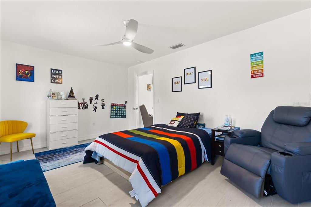 812 Chastain Road Seffner, FL 33584 - Photo 16 of 26 a bedroom with a bed couch and a desk