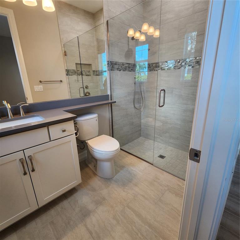 512 Blue Shell Loop Sarasota, FL 34240 - Photo 34 of 44 a bathroom with a shower a toilet and sink
