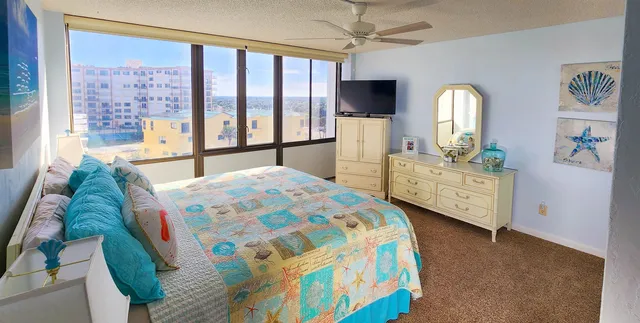 a bedroom with a bed dresser and a window