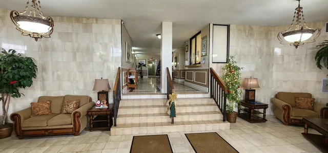 a view of a patio with table and chairs and potted plants