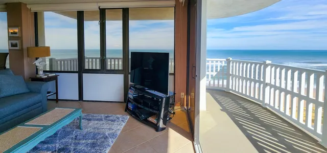 a view of a hallway with wooden floor and furniture