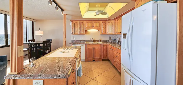 a kitchen with a sink stove and refrigerator