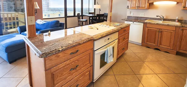 a kitchen with stainless steel appliances granite countertop a sink and cabinets