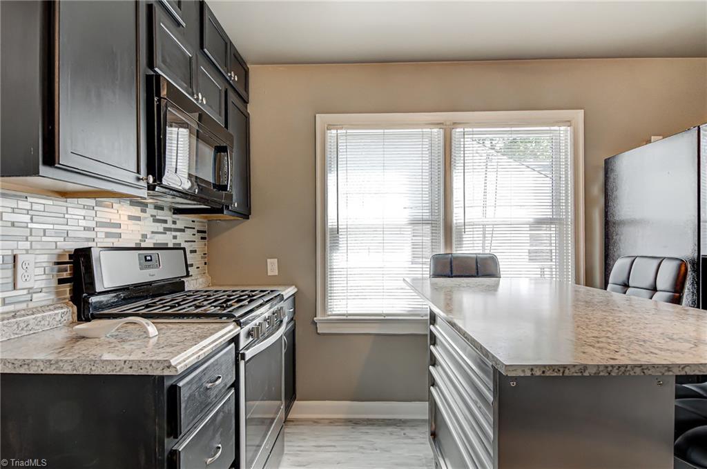 1404 Cook Street High Point, NC 27262 - Photo 10 of 21 Gas stove and movable island that provides loads of storage and plenty of seating..