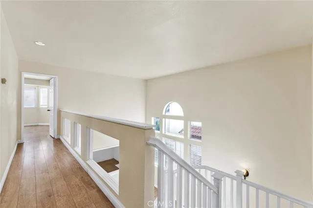 a view of a livingroom with wooden floor and stairs