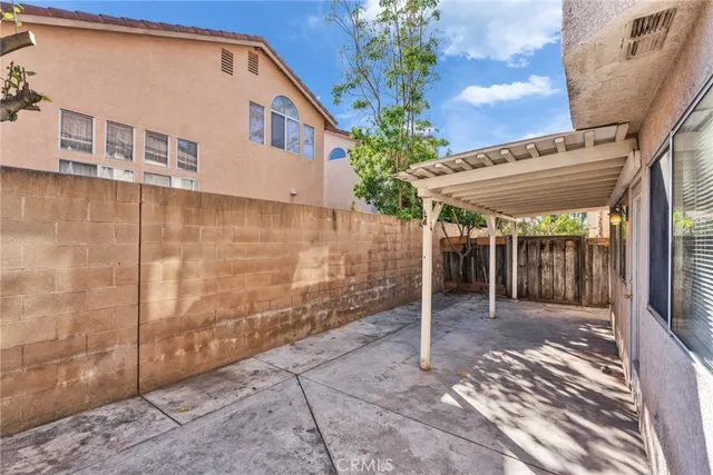 a backyard of a house with table and chairs