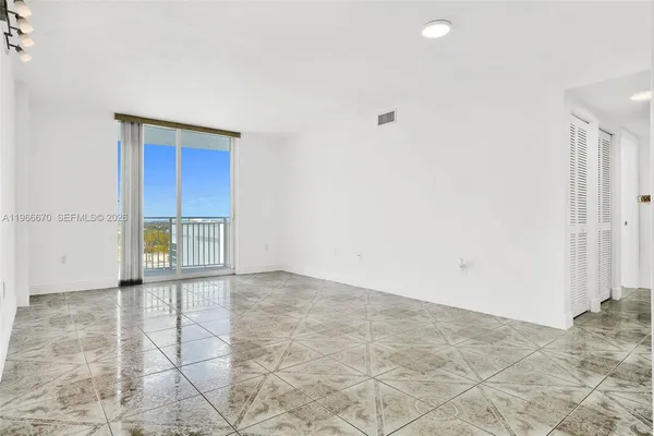 a kitchen with stainless steel appliances granite countertop a refrigerator a stove a sink and a white cabinets