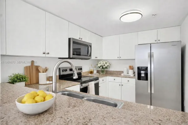 a kitchen with a sink a stove and refrigerator