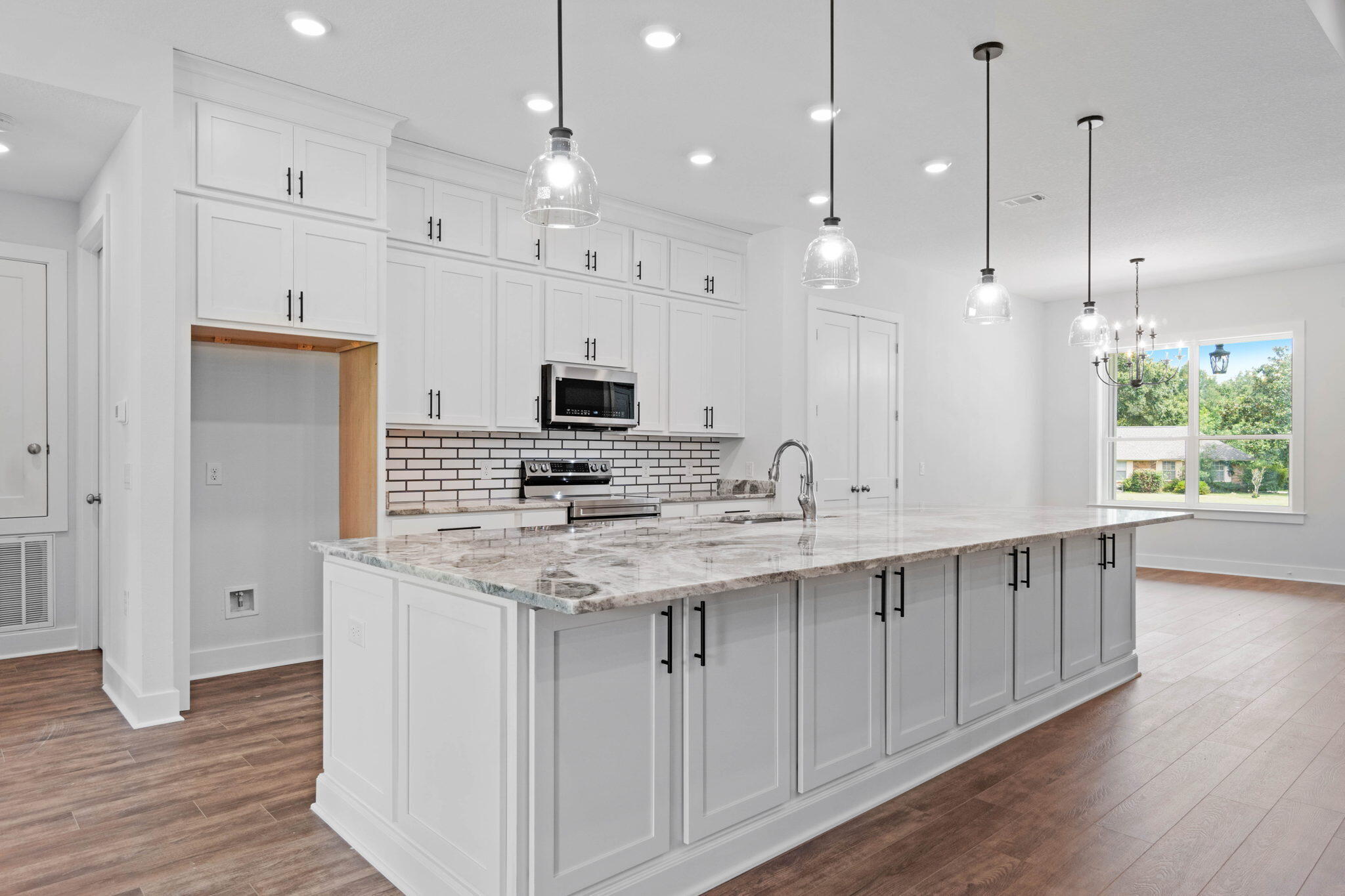 6949 Snug Waters Road Navarre, FL 32566 - Photo 15 of 51 a kitchen with kitchen island a sink stainless steel appliances and window
