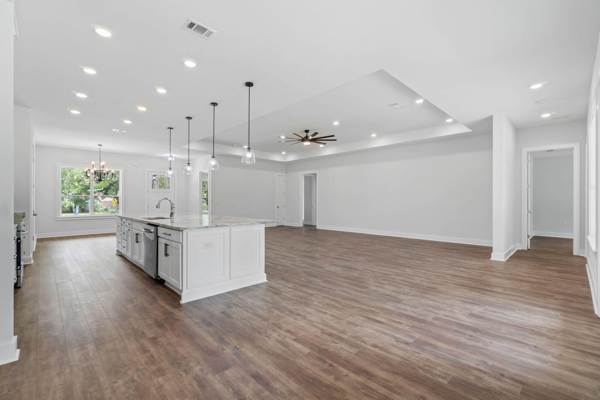 6949 Snug Waters Road Navarre, FL 32566 - Photo 22 of 51 a large room with kitchen view and wooden floor