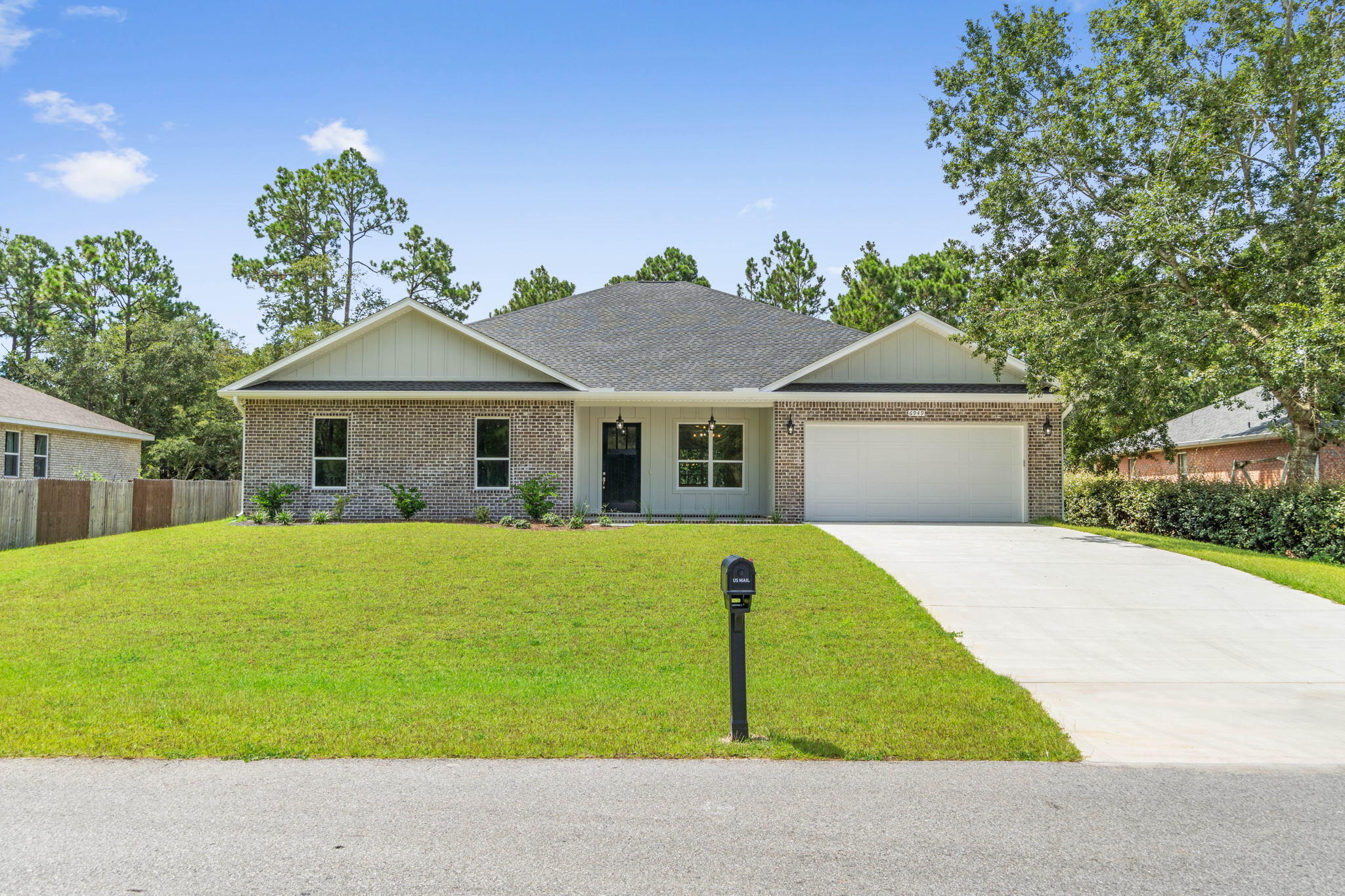 6949 Snug Waters Road Navarre, FL 32566 - Photo 4 of 51 a house view with a garden space
