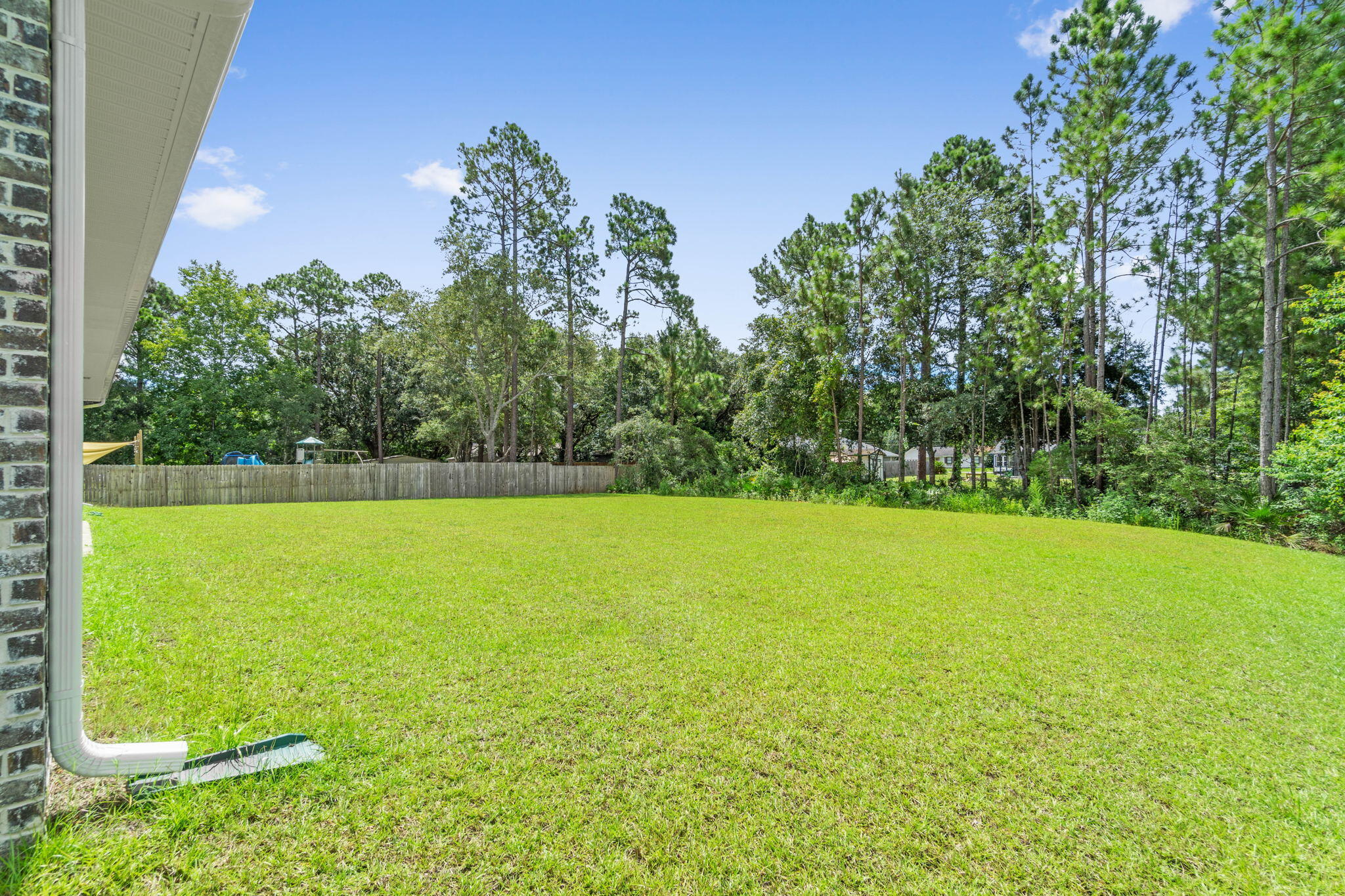 6949 Snug Waters Road Navarre, FL 32566 - Photo 47 of 51 a view of a yard with a trees