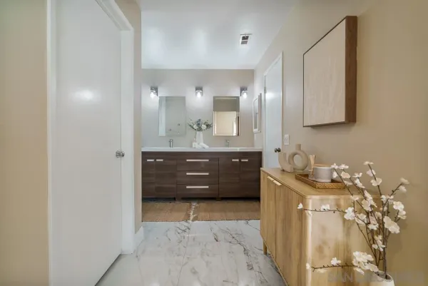 a bathroom with a bathtub shower sink vanity and a toilet