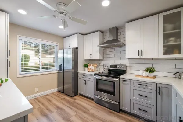 a kitchen with stainless steel appliances granite countertop a stove a refrigerator and a microwave