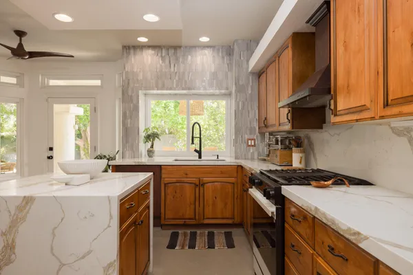 a kitchen that has a sink and a stove in it