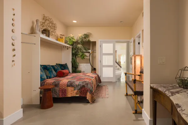 a bedroom with a bed and a window