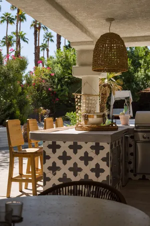 a patio with a table and chairs under an umbrella