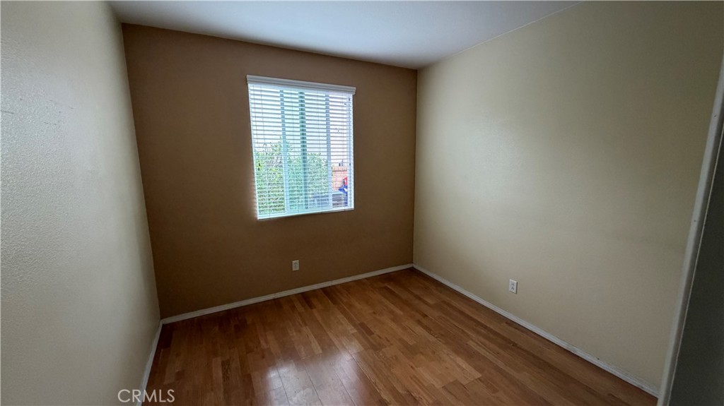 7134 Cumberland Place Rancho Cucamonga, CA 91739 - Photo 7 of 22 an empty room with wooden floor and windows