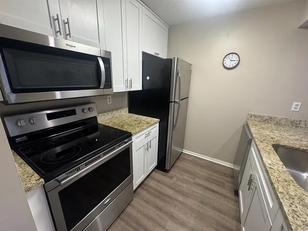 a kitchen with a stove and a microwave