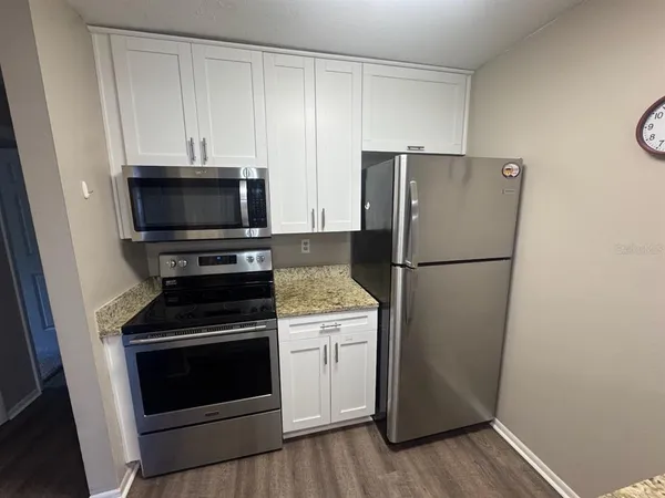 a kitchen with a refrigerator stove and microwave