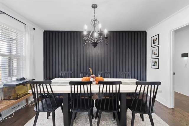 a dining room with furniture and wooden floor