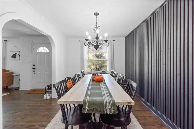 a bedroom with a large bed and a chandelier
