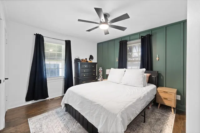 a bedroom with a bed and a dresser in it