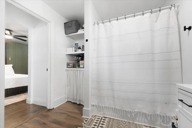 a view of a hallway with wooden floor and closet