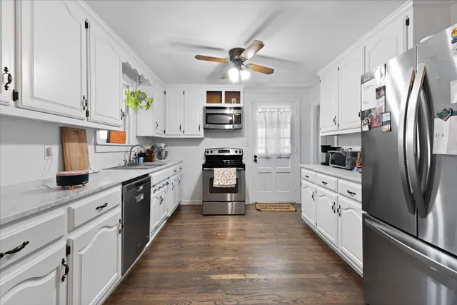 a kitchen with a cabinets and wooden floor