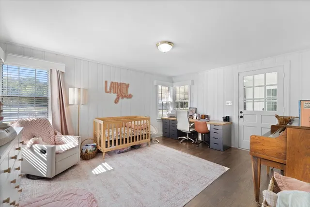 a bedroom with furniture and a wooden floor