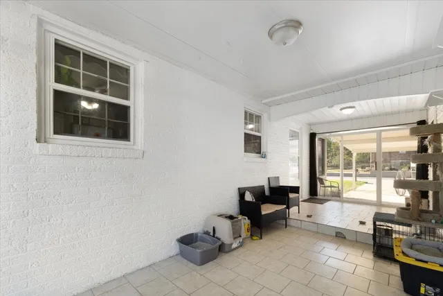 a living room with furniture a rug and a large window