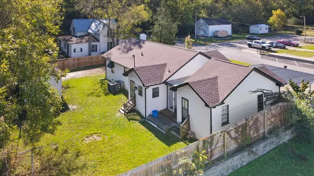 a front view of house with a garden