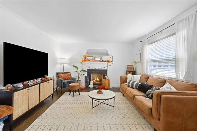 a living room with furniture a flat screen tv and a large window