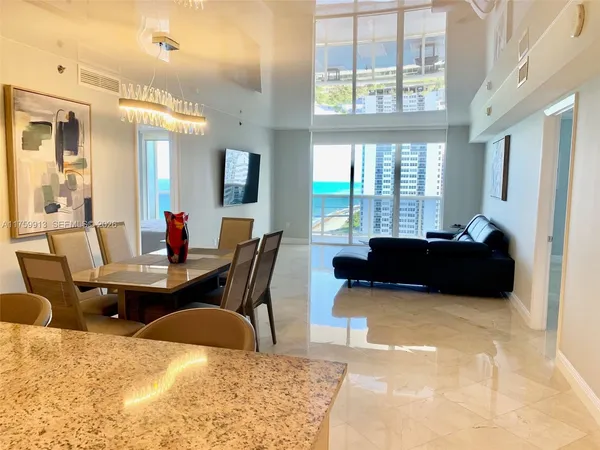 a living room with furniture window and wooden floor