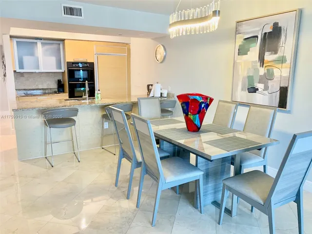 a view of a dining room with furniture and window
