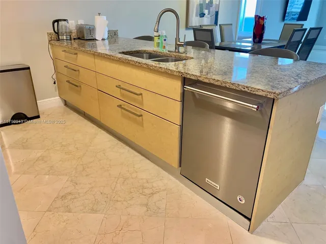 a kitchen with sink and mirror