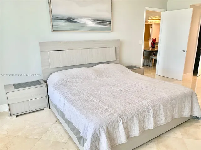 a large white bed in a white room