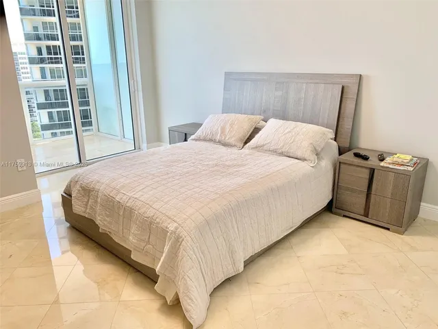 a bed sitting in a bedroom next to a window