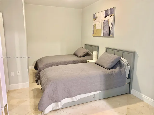 a bedroom with a bed and wall painting